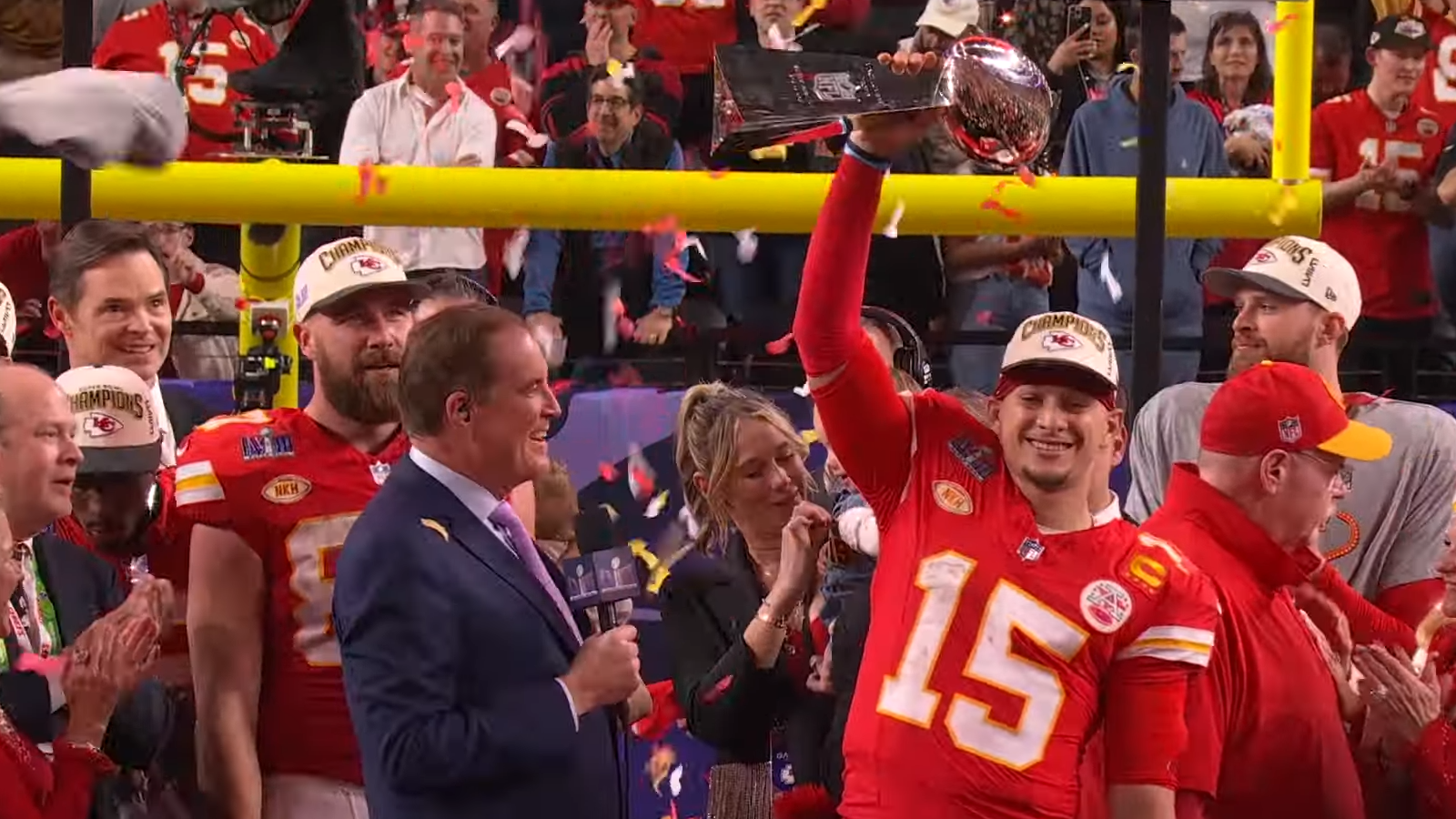 Patrick Mahomes proudly hoisting up the MVP trophy at the Super Bowl LVIII awarding ceremony